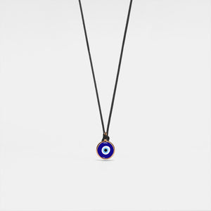 A Turkish evil eye necklace with a blue enamel charm on a black rope chain.