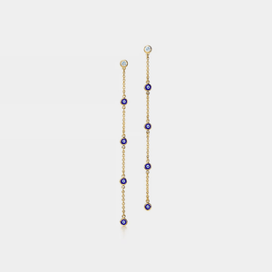 Gold chain earring with blue beads on a white background