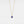 Gold necklace with a blue evil eye pendant on a light gray background