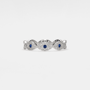 Silver evil eye ring with blue gemstones and diamond accents on a white background