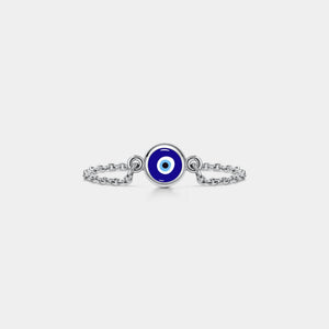 Silver chain ring with a blue evil eye charm on a white background