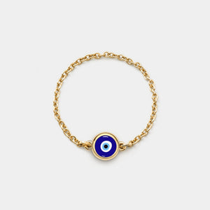 Gold chain ring with a blue evil eye charm on a white background