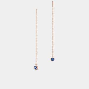 Pair of gold chain earrings with small round charms on a light gray background