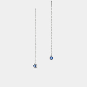 Pair of silver earrings with blue evil eye charms on a white background