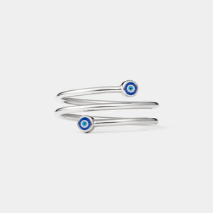 Silver three row ring with blue evil eye charms on a light gray background
