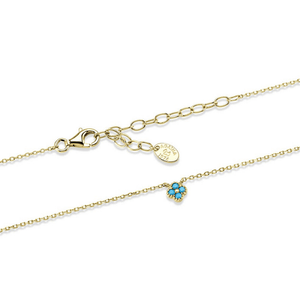 Gold bracelet with a heart-shaped turquoise charm on a white background