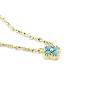 Gold necklace with a turquoise heart pendant on a white background