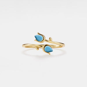 Gold bracelet with turquoise stones on a white background