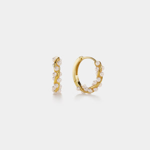 Gold hoop earrings with pearls on a white background