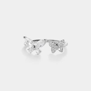 Silver butterfly ring on a light gray background