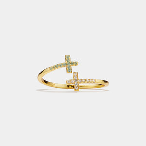Gold ring with cross design on a light gray background