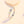 Silver ring with gold moon and star accents on a light beige background