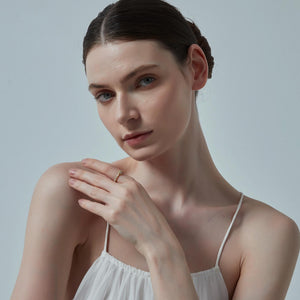 Woman wearing a white dress against a plain background