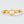 Gold ring with an opal stone and small diamonds on a light gray background