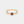 Gold ring with a red gemstone on a white background