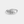 Silver ring with floral engraving on a light gray background