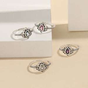 Set of silver rings with gemstones on a beige background