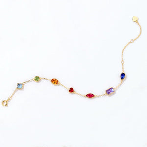 Gold bracelet with colorful gemstones on a white background