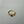 Gold ring with a black gemstone on a gray background