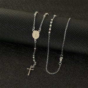 A collection of Virgin Mary cross drop Y necklaces with varying lengths, displayed on a white stand. The necklaces feature gold and silver colors with cross pendants and beaded chains.