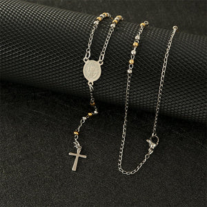A collection of Virgin Mary cross drop Y necklaces with varying lengths, displayed on a white stand. The necklaces feature gold and silver colors with cross pendants and beaded chains.
