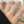 Silver rings on a hand with a blurred book background