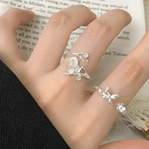 Silver rings on a hand with a blurred book background