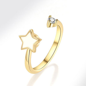 Gold spinner ring with star design and diamond on a white background
