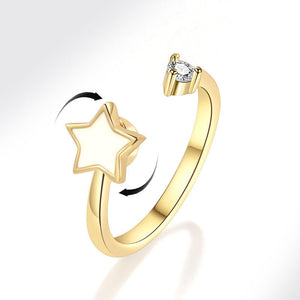 Gold spinner ring with star design and diamond on a white background