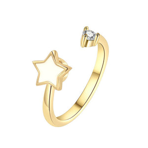 Gold spinner ring with star design and diamond on a white background