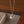 Silver necklace with a floral pendant on a reflective surface