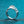 Silver ring with a diamond on a teal background