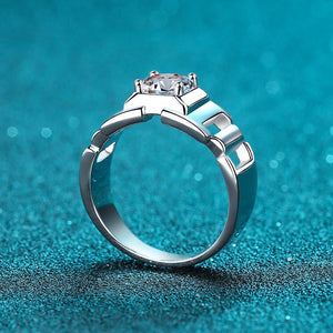 Silver ring with a diamond on a teal background