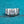 Silver ring with a large diamond on a blue glittery background