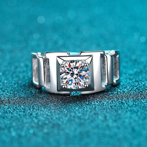 Silver ring with a large diamond on a blue glittery background