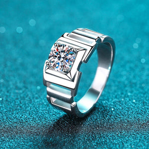 Silver ring with a large diamond on a blue textured background