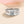 Silver ring with a diamond on a beige background