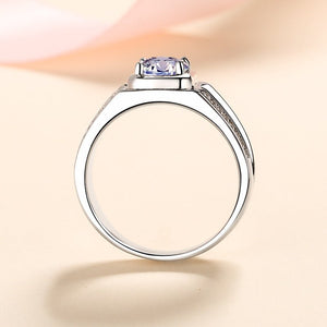 Silver ring with a central gemstone on a light background