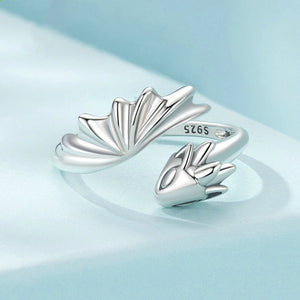 Silver fan-shaped earrings on a light blue background