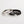 Two rings, one silver and one black, on a light gray background