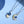Two necklaces with star and moon pendants on a blue background