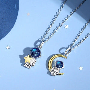 Two necklaces with star and moon pendants on a blue background