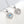 Heart-shaped silver pendants with blue gemstones on a white background