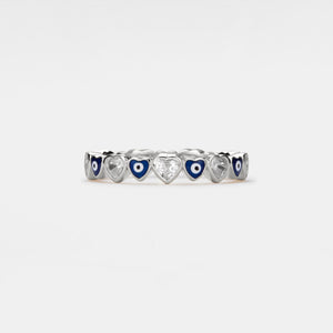 Silver ring with heart-shaped evil eye and gemstones on a white background