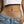 Person wearing a colorful beaded waist chain with a plain background