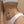 Pearl and gold chain waist belt worn by a person on a beige background