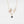 Delicate gold necklace with a butterfly pendant on a white background