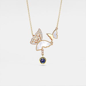 Delicate gold necklace with a butterfly pendant on a white background