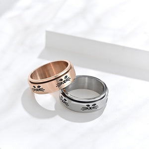 Two rings, one rose gold and one silver, with cat face designs on a white background.