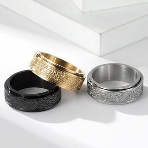 Three rings in black, gold, and silver on a white background
